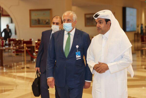 U.S. special envoy for Afghanistan Zalmay Khalilzad (C) and Qatar's envoy on counter-terrorism Mutlaq al-Qahtani (R) walk down a hotel lobby in Qatar's capital Doha during an international meeting on the escalating conflict in Afghanistan on Aug. 10, 2021. (Karim Jaafar/AFP via Getty Images)