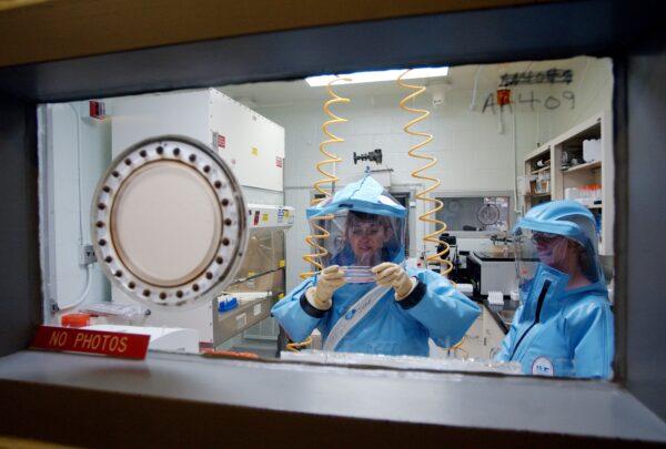 Personnel working on research inside the bio-level 4 lab at the U.S. Army Medical Research Institute of Infectious Diseases at Fort Detrick on Sept. 26, 2002. (Olivier Douliery/AFP via Getty Images)