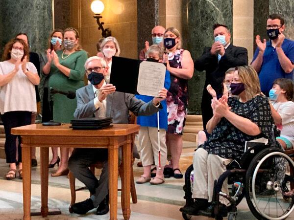 Wisconsin Gov. Tony Evers vetoes Republican bills during a news conference in the Capitol rotunda in Madison, Wis., on Aug. 10, 2021. (Scott Bauer/AP Photo)