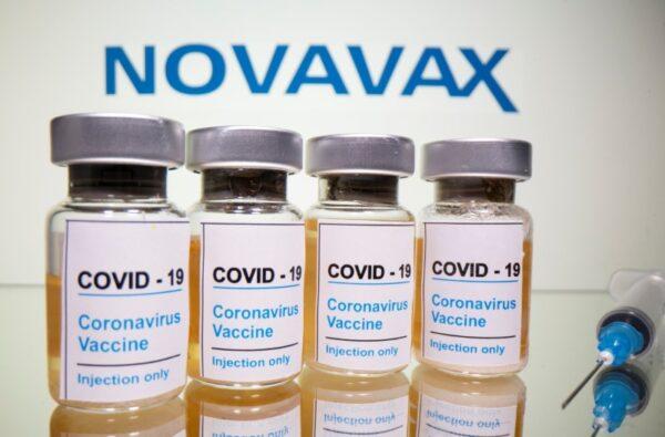 Vials with a sticker reading, "COVID-19 / Coronavirus vaccine / Injection only" and a medical syringe are seen in front of a displayed Novavax logo in this illustration taken Oct. 31, 2020. (Dado Ruvic/Illustration/Reuters)