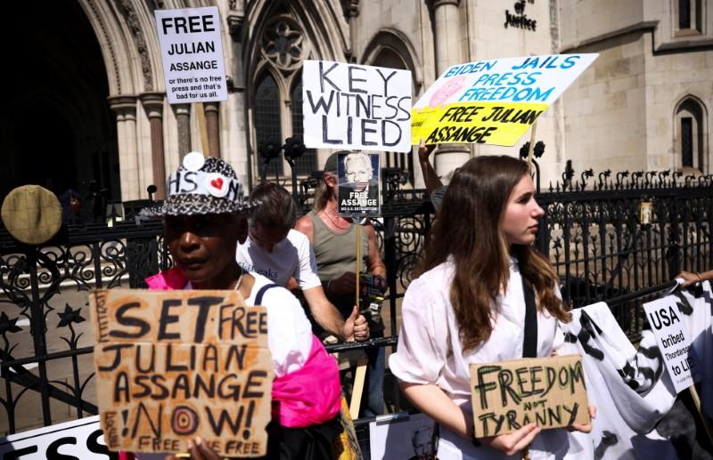 Supporters of Wikileaks founder Julian Assange gather outside the Royal Courts of Justice during the U.S. government appeal against a ruling by a British Judge that Assange should not be extradited, in London, Britain, August 11, 2021. (Henry Nicholls/Reuters)