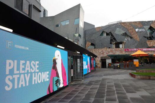 Signage for people to stay home is seen at Federation Square in downtown Melbourne, Australia, on Aug. 6, 2021 (Con Chronis/AFP via Getty Images)