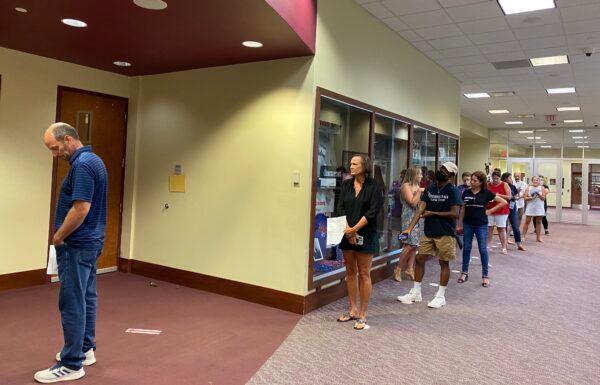 Speakers waited in a group of ten outside the board room while other speakers waited outdoors or in their cars during the Loudoun County Public School Board meeting on Aug. 10, 2021. (Terri Wu/The Epoch Times)
