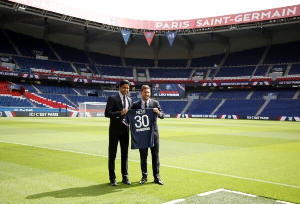 Paris St Germain's Lionel Messi and president Nasser Al-Khelaifi pose with a shirt on the pitch after the press conference in Parc des Princes, Paris, France, on Aug. 11, 2021. (Sarah Meyssonnier/Reuters)