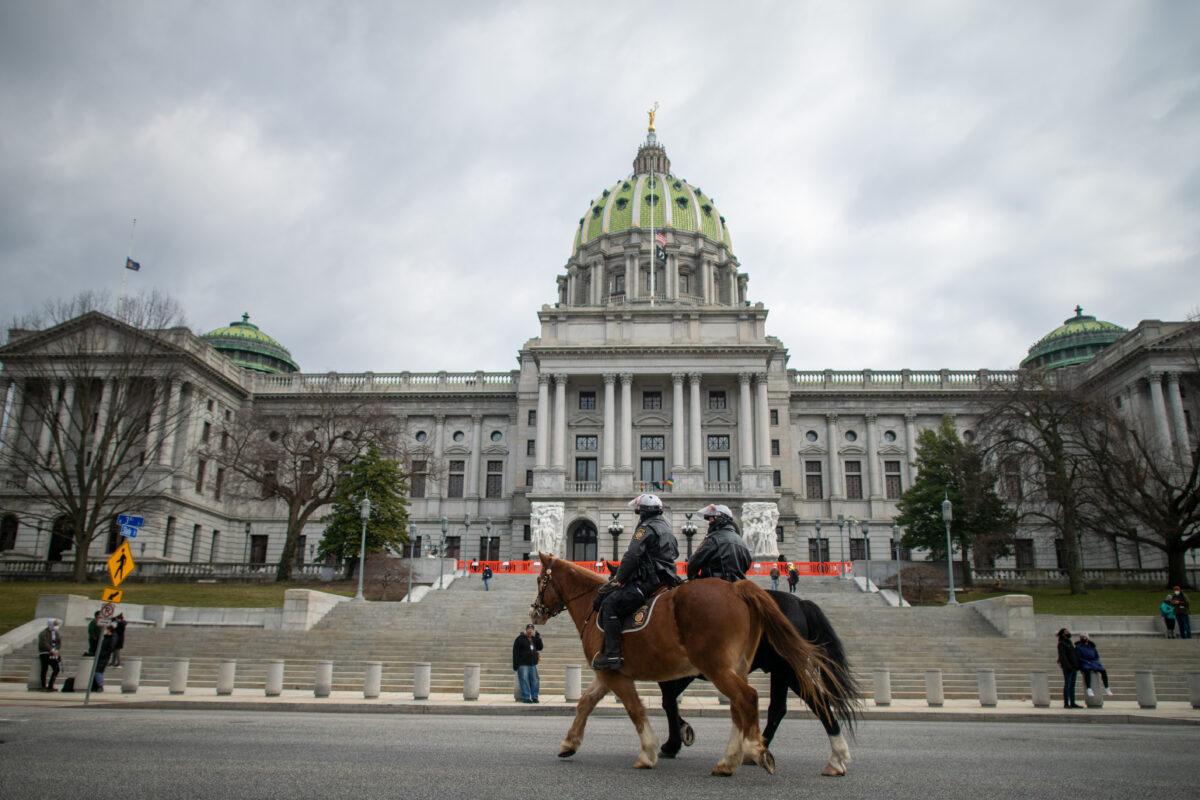 Police officers on horseback patrol in front of the Pennsylvania Capitol Building in Harrisburg, Pa., on Jan. 17, 2021. (Mark Makela/Getty Images)