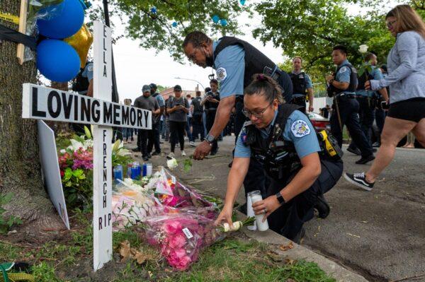 Chicago police officers leave flowers at a memorial for slain officer Ella French at 63rd and Bell drives in Chicago, Ill., on Aug. 9, 2021. (Tyler LaRiviere/Chicago Sun-Times via AP)