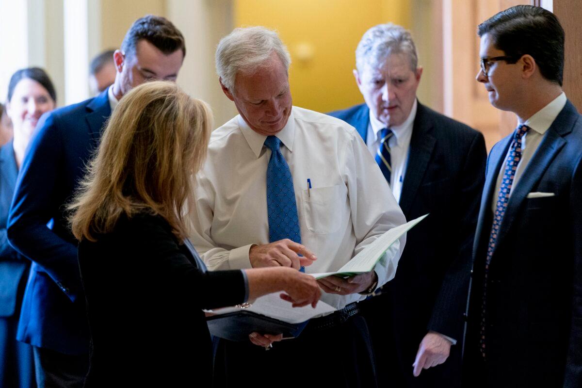 (L-R) Sen. Marsha Blackburn (R-Tenn.), Sen. Ron Johnson (R-Wis.), and Sen. John Kennedy (R-La.), leave a Republican policy luncheon as the Senate moves from passage of the infrastructure bill to focus on a massive $3.5 trillion budget resolution, at the U.S. Capitol in Washington on Aug. 10, 2021. (Andrew Harnik/AP Photo)
