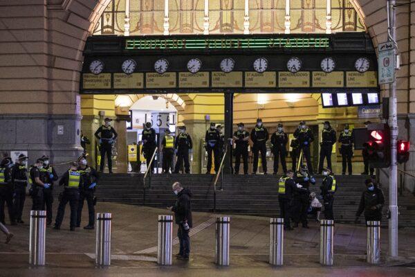 A Police presence is seen at Flinders Street Station during a proposed anti-lockdown protest in Melbourne, Australia, on Aug. 11, 2021. Regional Victoria's lockdown is over but people in Melbourne are still days from finding out when theirs will end. (AAP Image/Daniel Pockett)