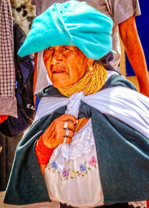 An Otavaleño Indian woman dressed in traditional outfit at the great Indian market in Otavalo. (Copyright Fred J. Eckert)