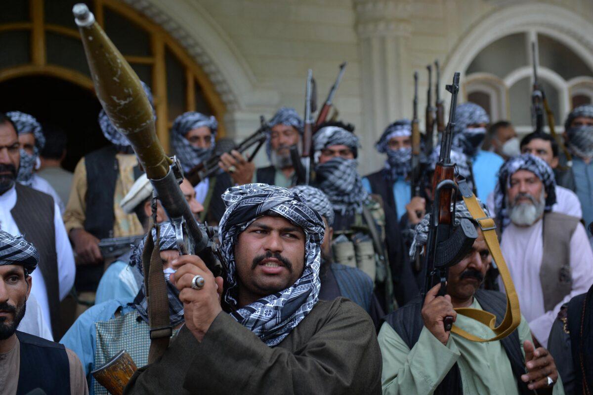 Afghan militia gather with their weapons to support Afghanistan security forces against the Taliban in Afghan warlord and former Mujahideen leader Ismail Khan's house in Herat, Afghanistan, on July 9, 2021. (Hoshang Hashimi/AFP via Getty Images)
