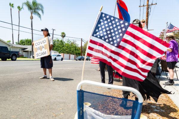 A coronavirus protestor stands in front of Hewes Middle School in Santa Ana, Calif., on Aug. 2, 2021. (John Fredricks/The Epoch Times)