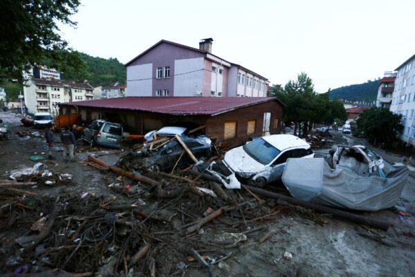 Destroyed cars in a street after floods and mudslides in Bozkurt town of Kastamonu province, Turkey, on Aug. 12, 2021. (IHA via AP)