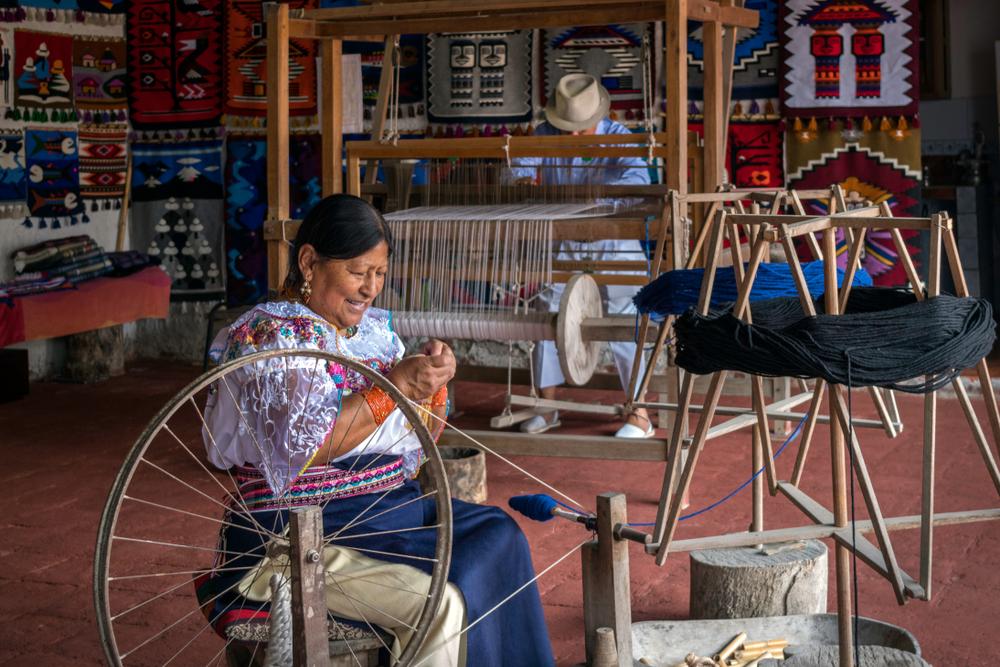 A woman produces indigenous fabrics from the Andean Quechua culture. (Ripio/Shutterstock)