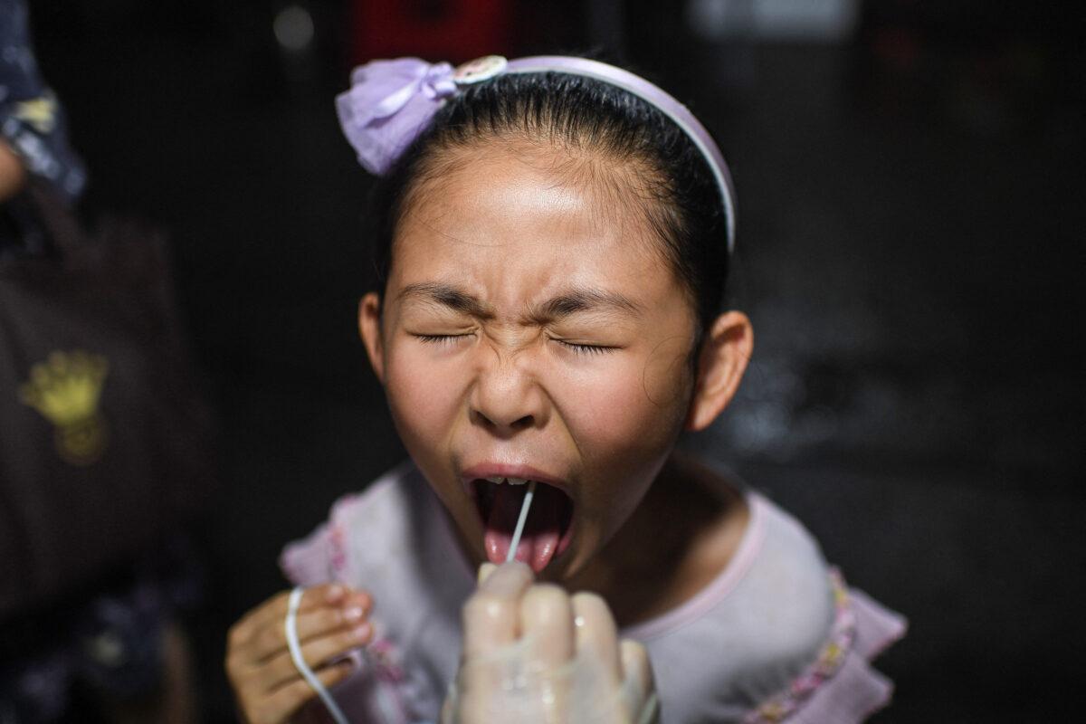 A child receives a COVID-19 test at a residential area in Wuhan, in China's Hubei Province, on Aug. 11, 2021. (STR/AFP via Getty Images)