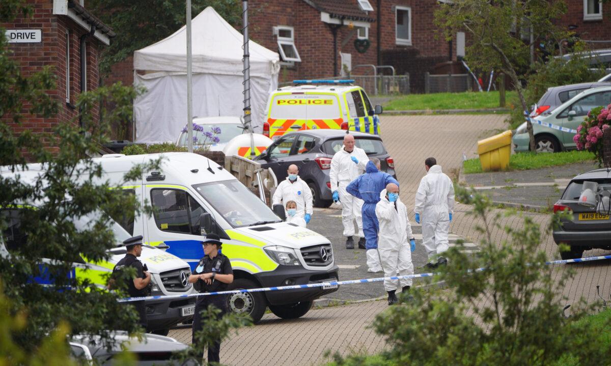 Forensic officers in Biddick Drive in the Keyham area of Plymouth where six people, including the offender, died of gunshot wounds in a firearms incident Thursday evening, in Plymouth, England, on Aug. 13, 2021. (Ben Birchall/PA)
