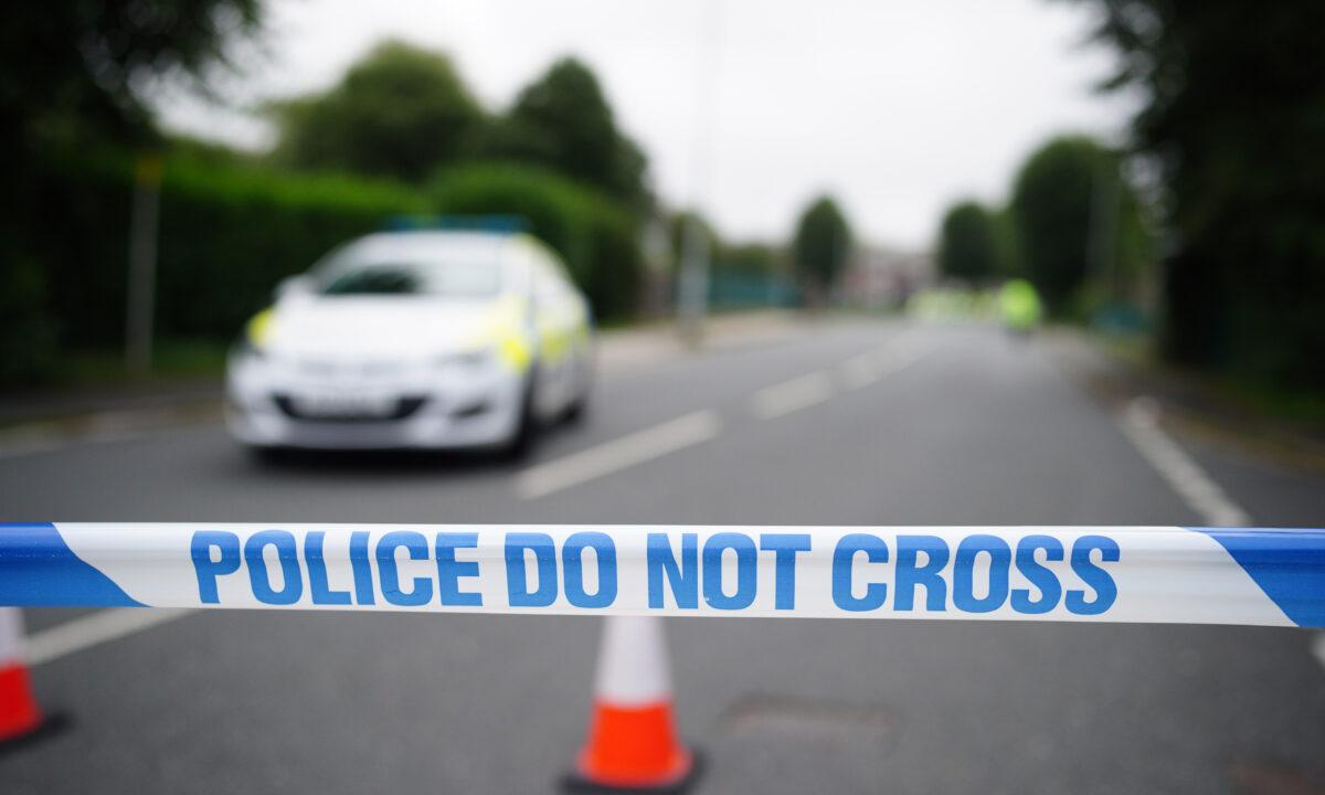 A police cordon is seen where six people, including the offender, died of gunshot wounds in a firearms incident in the Keyham area of Plymouth, England, on Aug. 13, 2021. (Ben Birchall/PA)