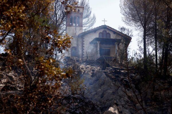 Burnt vegetation is pictured near a church in the Monte Catillo nature reserve in Tivoli, near Rome, Italy, on Aug. 13, 2021. (Guglielmo Mangiapane/Reuters)