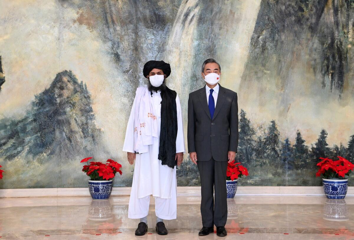 Chinese State Councilor and Foreign Minister Wang Yi meets with Mullah Abdul Ghani Baradar, political chief of Afghanistan's Taliban in Tianjin, China, on July 28, 2021. (Li Ran/Xinhua via Reuters)