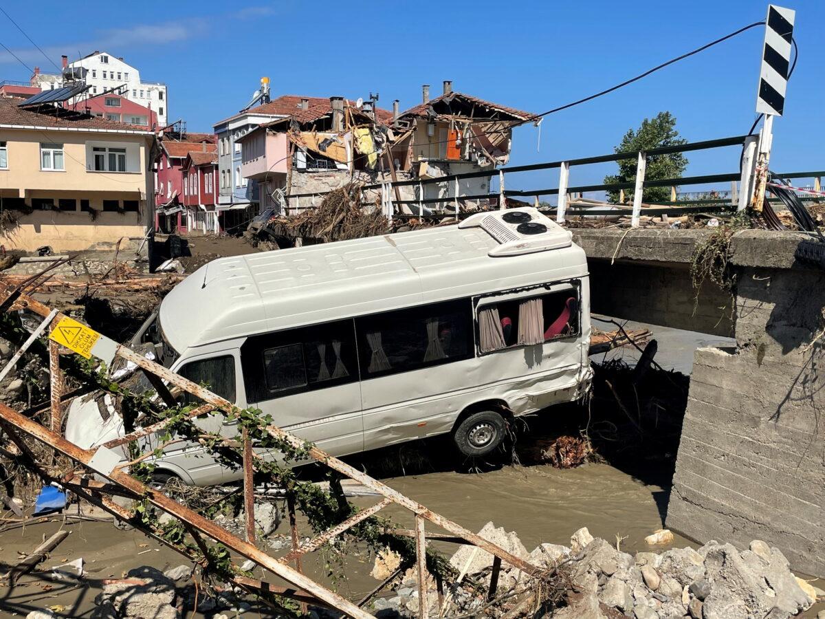 A damaged vehicle and a partially collapsed building are seen following the flash floods that swept through towns in the Turkish Black Sea region, in the town of Ilisi, in Kastamonu province, Turkey, on Aug. 15, 2021. (Mehmet Emin Caliskan/Reuters)