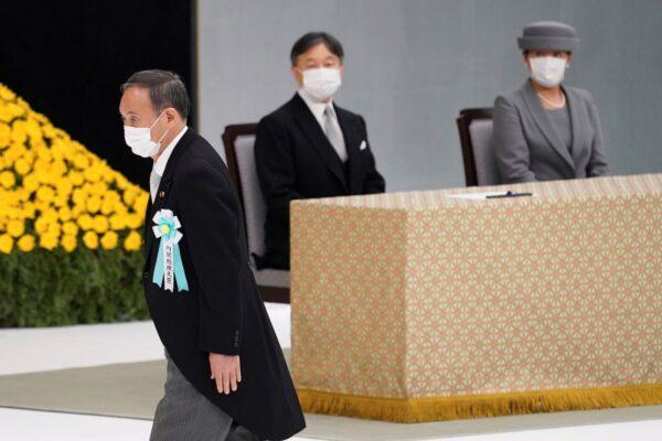 Japanese Prime Minister Yoshihide Suga walks to deliver a speech during a ceremony to mark the 76th anniversary of Japan's surrender in World War II at Budokan hall in Tokyo, Japan, on Aug. 15, 2021. (Toru Hanai/Pool Photo via AP)