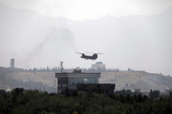 A U.S. Chinook helicopter flies over the U.S. Embassy in Kabul, Afghanistan, on Aug. 15, 2021. (Rahmat Gul/AP Photo)