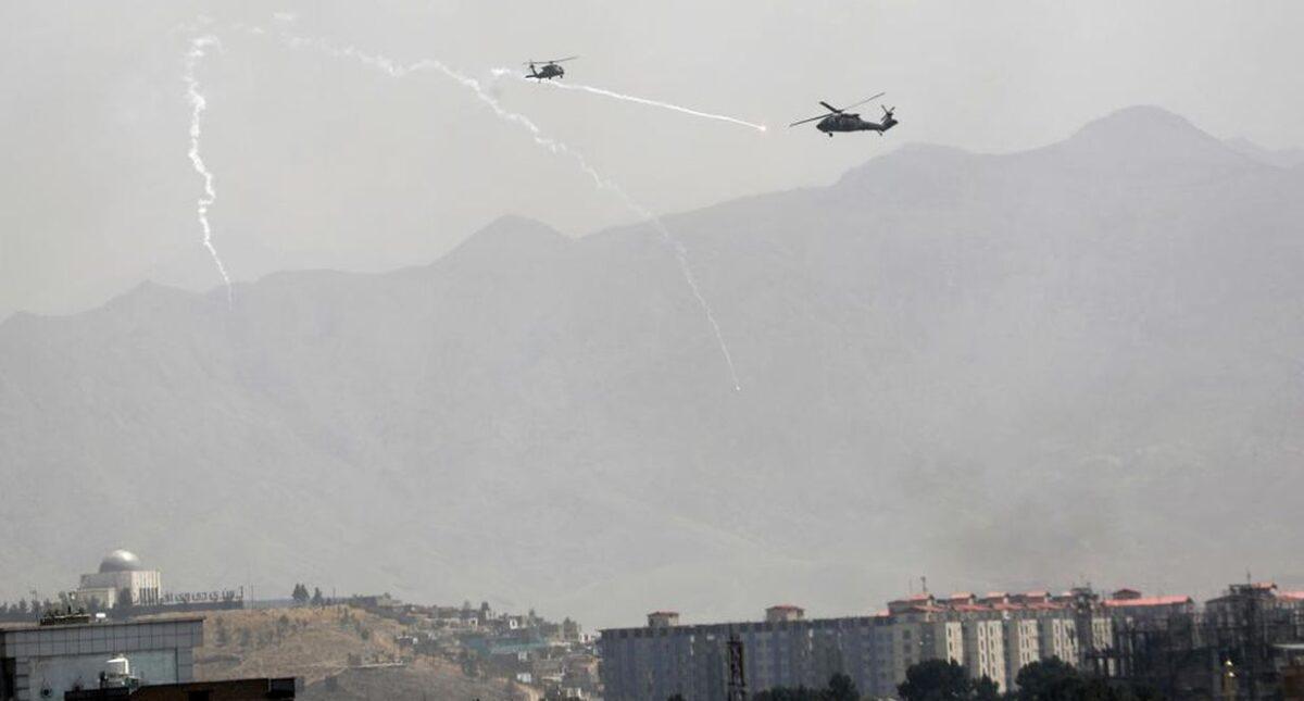 A U.S. helicopter flies over the city of Kabul, Afghanistan, on Aug. 15, 2021. (Rahmat Gul/AP Photo)