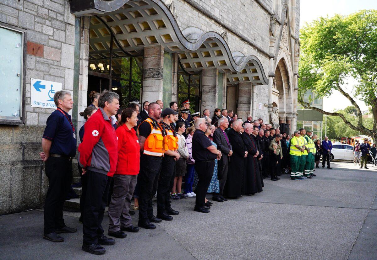 People take part in a minute's silence outside Plymouth Guildhall in memory of the five people that were killed by gunman Jake Davison in a firearms incident in Plymouth, United Kingdom, on Aug. 16, 2021. (Ben Birchall/PA)
