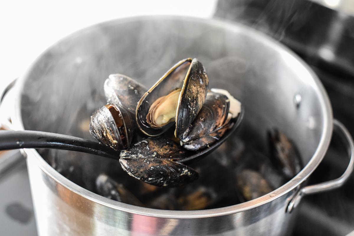 Steam the mussels until they open, then transfer them to a separate bowl while you finish the sauce. (Audrey Le Goff)