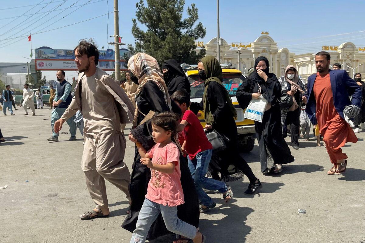People try to get into Hamid Karzai International Airport in Kabul, Afghanistan, on Aug. 16, 2021. (Reuters/Stringer)