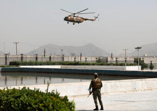 A military helicopter carrying Afghan President Ashraf Ghani prepares to land near the parliament in Kabul, Afghanistan, on Aug. 2, 2021. (Stringer/Reuters)