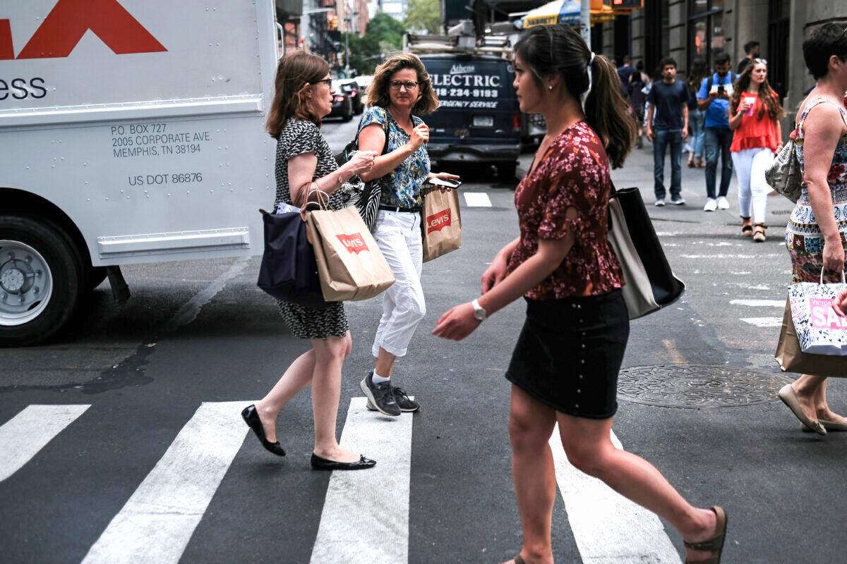 People walk along a street in lower Manhattan in New York City on July 5, 2019. (Spencer Platt/Getty Images)