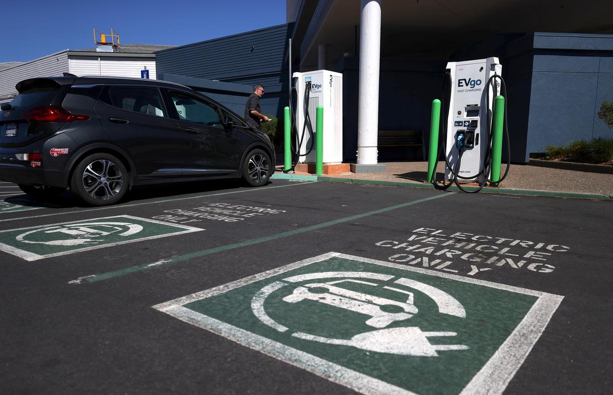 An electric car owner prepares to charge his car at an electric car charging station in Corte Madera, Calif., on Sept. 23, 2020. (Justin Sullivan/Getty Images)