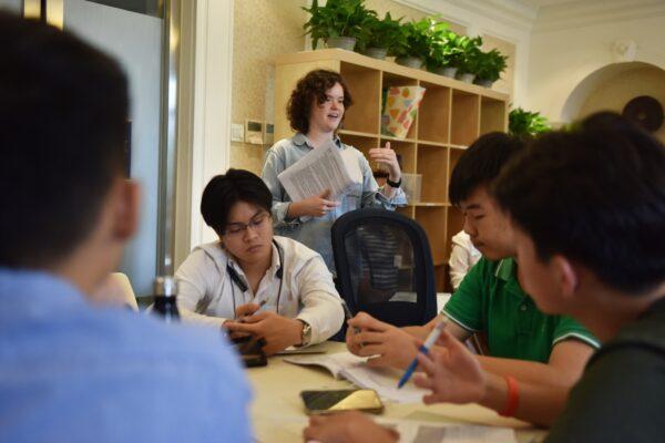 A college counselor speaks with students during a class at Elite Scholars China, a boutique college consultancy where students can receive application guidance, mentoring, and advice on the best courses for their interests and skills, in Beijing, China on July 19, 2019. (Greg Baker/AFP via Getty Images)
