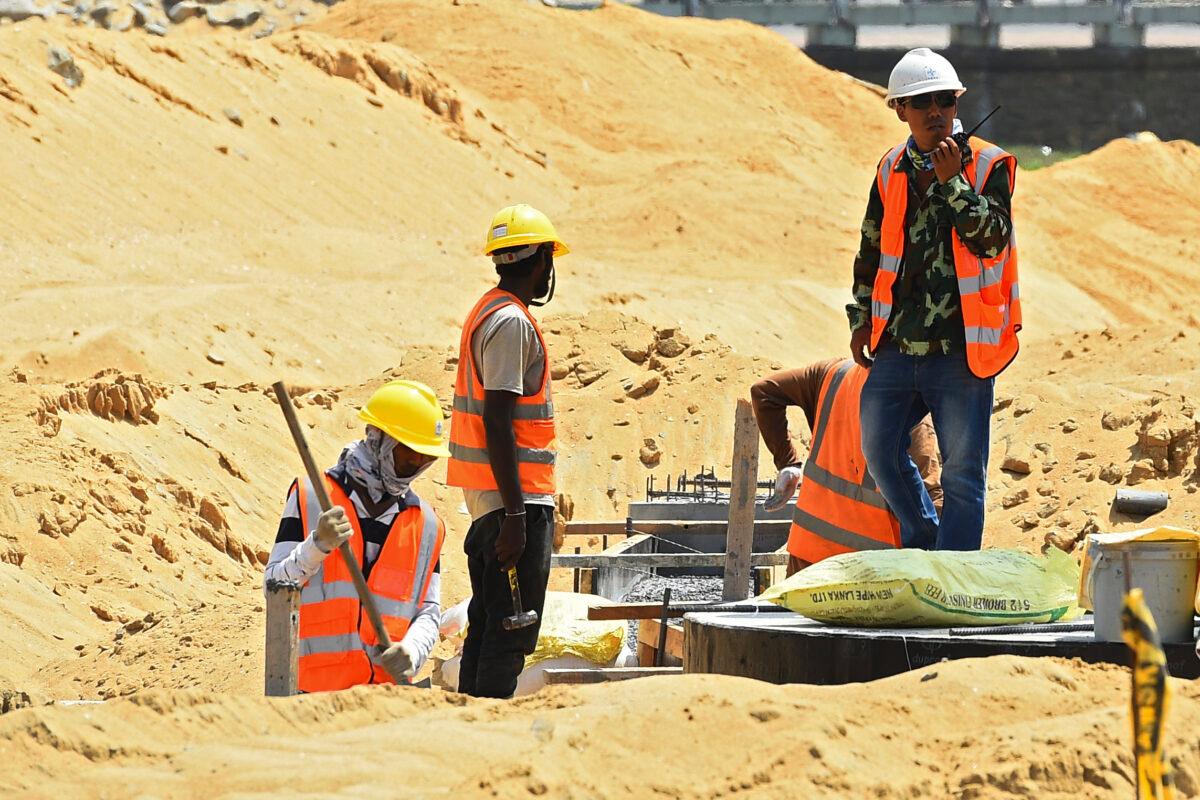 Chinese and Sri Lankan laborers work at a construction site on reclaimed land, part of a Chinese-funded project for Port City, Colombo, Sri Lanka, on Feb. 24, 2020. (Ishara S. Kodikara/AFP)