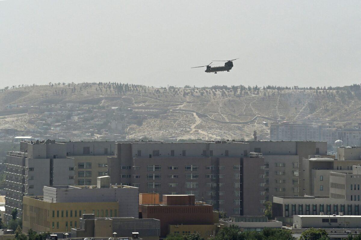 A U.S. military helicopter flies above the U.S. Embassy in Kabul, Afghanistan on Aug. 15, 2021. (Wakil Kohsar/AFP via Getty Images)