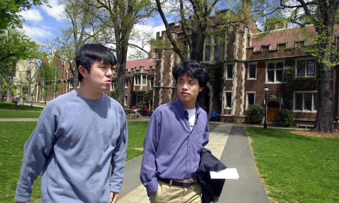 Zhen Jianfeng (L), 23, and Deng Dayi (R), 23, both from China, walk on the Princeton University campus in Princeton, N.J., on April 23, 2002. (William Thomas Cain/Getty Images)