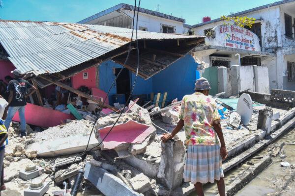 A woman stands in front of a destroyed home in the aftermath of an earthquake in Les Cayes, Haiti on Aug. 14, 2021. (Duples Plymouth/AP Photo)