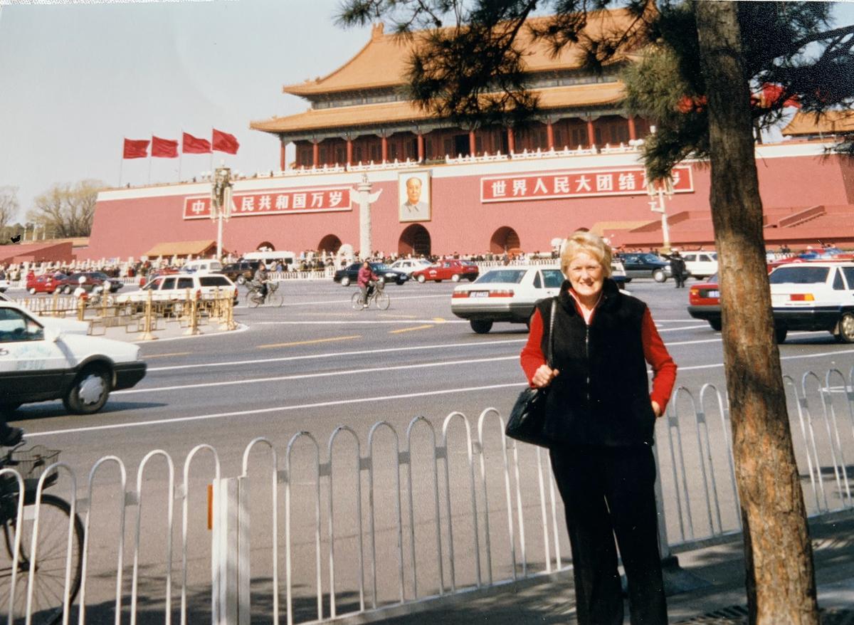 1964 Tokyo Olympic silver-medalist Jan Becker posing for a photo opposite Tiananmen Square, Beijing, China, days before her human rights protest on March 7, 2002. (Courtesy of Jan Becker)