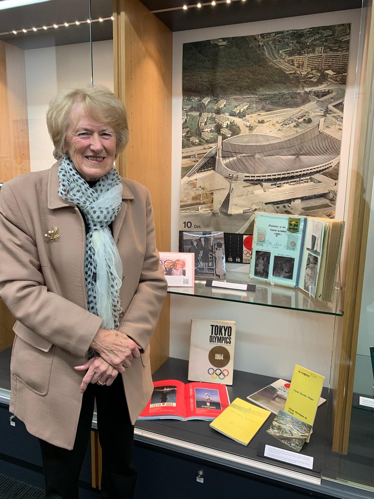 Jan Becker visiting the "Memories of Tokyo 1964" exhibition at the Consulate-General of Japan in Melbourne, Australia, on May 19, 2021. Items such as her scrapbook and commemorative stamps are currently on display. (Courtesy of Jan Becker)