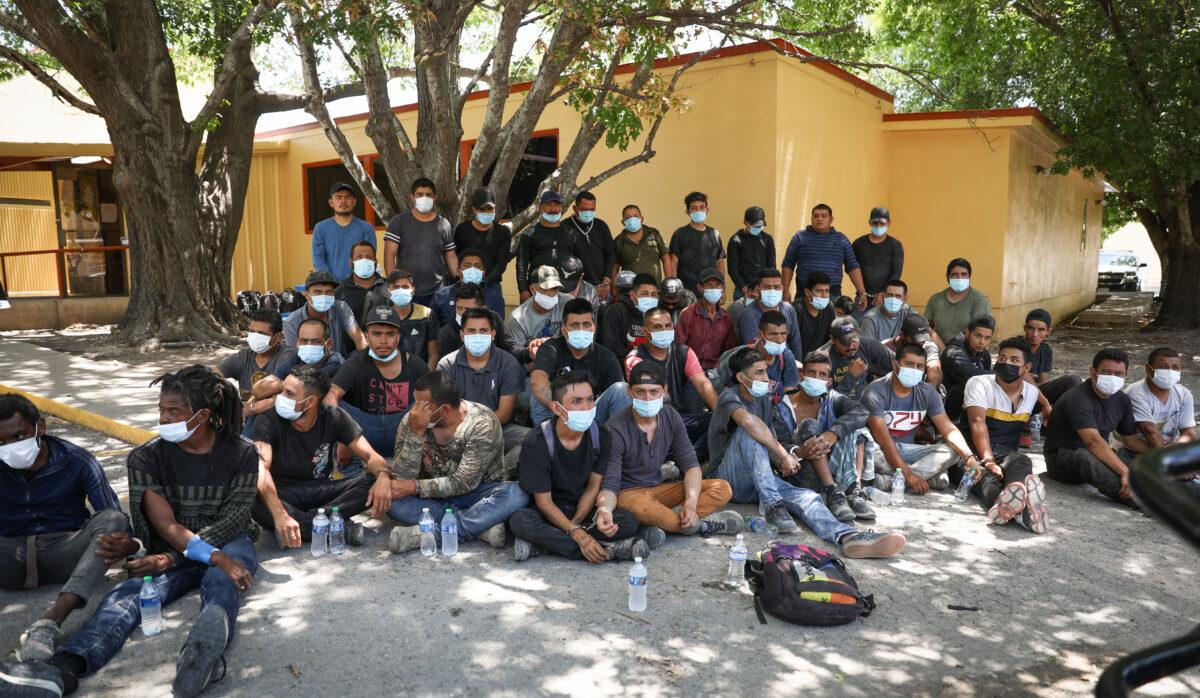 A total of 52 illegal immigrants from Mexico and Honduras wait to be booked for criminal trespass after being arrested by Texas State Troopers on local ranches, at the Kinney County Sheriff's Office in Brackettville on Aug. 8, 2021. (Charlotte Cuthbertson/The Epoch Times)