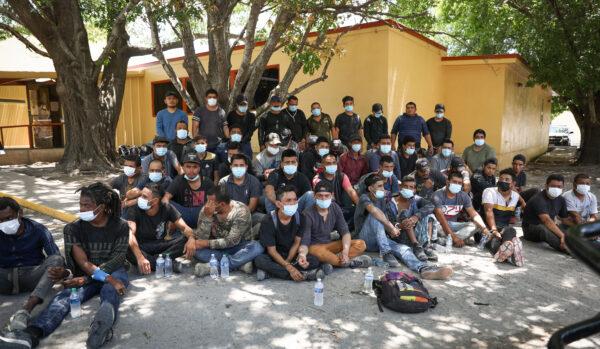 A total of 52 illegal immigrants from Mexico and Honduras wait to be booked for criminal trespass after being arrested by Texas State Troopers on local ranches, at the Kinney County Sheriffs Office in Brackettville, Texas, on Aug. 8, 2021. (Charlotte Cuthbertson/The Epoch Times)