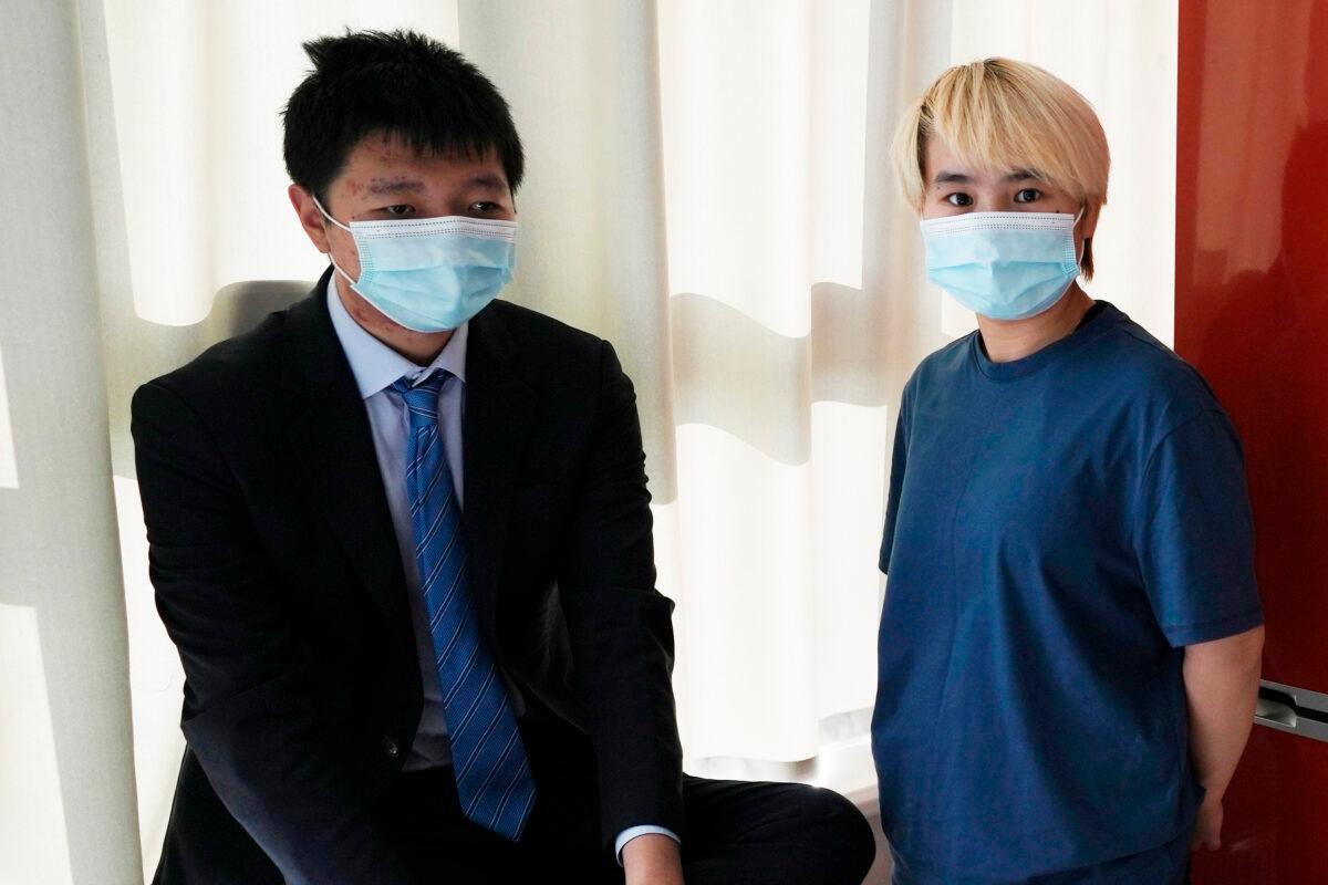 Wu Huan (R) and Wang Jingyu stand together in a safe house in Ukraine on June 30, 2021. Wu claims that she was held for eight days at a Chinese-run “black site” in Dubai along with at least two Uyghurs, in what may be the first evidence that China is operating a secret detention facility beyond its borders. She was on the run from the threat of being sent back to her home country because of her support of her fiance, Wang, a perceived Chinese dissident. (AP Photo)