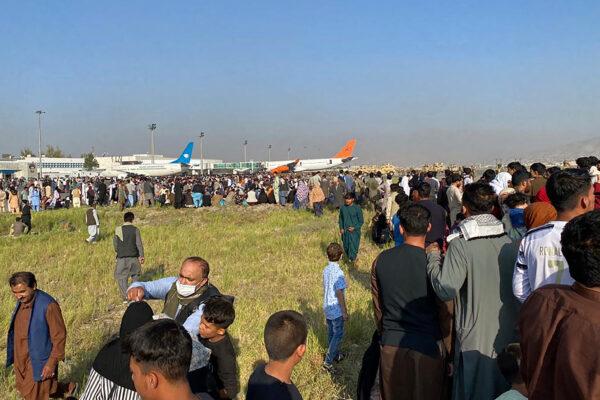 Afghans crowd at the airport in Kabul as they wait to leave on Aug, 16, 2021. (SHAKIB RAHMANI/AFP via Getty Images)