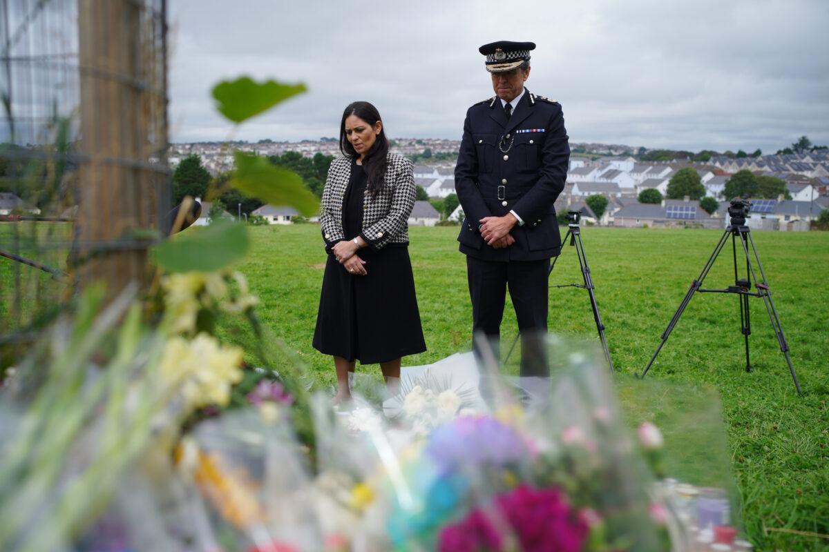Home Secretary Priti Patel and Chief Constable of Devon and Cornwall Police, Shaun Sawyer, visiting the tributes where five people were killed by gunman Jake Davison, in Plymouth, UK, on Aug. 14, 2021. (Ben Birchall/PA)
