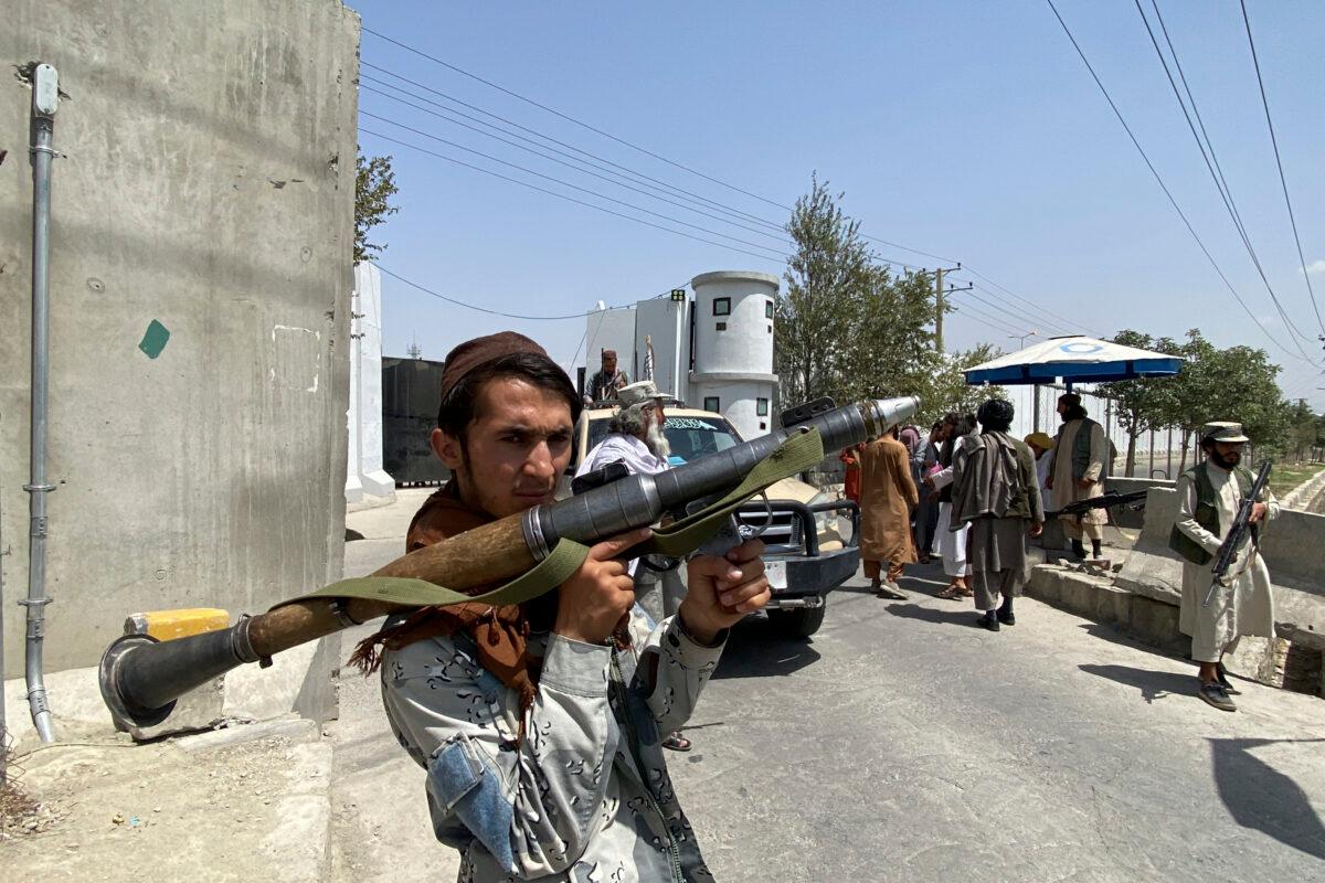 A Taliban fighter holds an RPG rocket-propelled grenade launcher as he stands guard with others at an entrance gate outside the Interior Ministry in Kabul on Aug. 17, 2021. (Javed Tanveer/AFP via Getty Images)