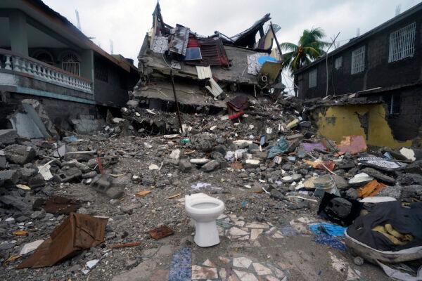 A building lays in ruins three days after a 7.2-magnitude earthquake, the morning after Tropical Storm Grace swept over Les Cayes, Haiti, on Aug. 17, 2021.(Fernando Llano/AP Photo)