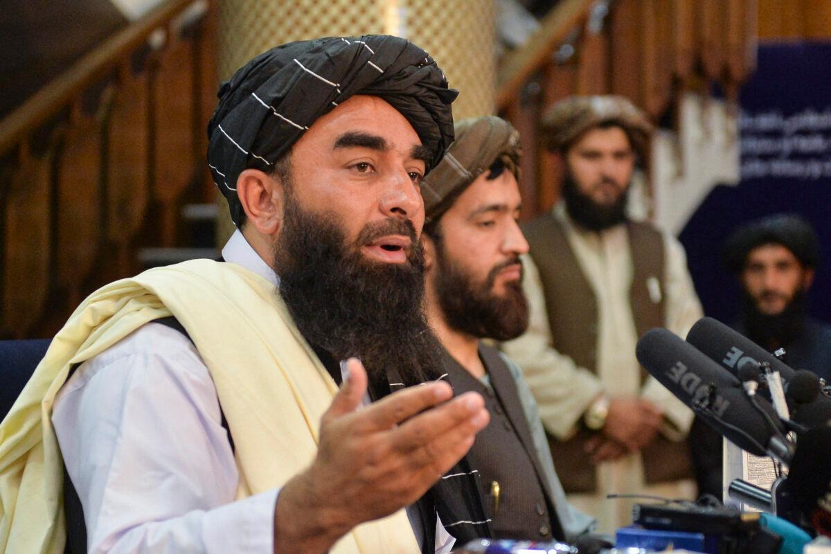 Taliban spokesperson Zabihullah Mujahid (L) gestures as he speaks during the first press conference in Kabul on Aug. 17, 2021 following the Taliban stunning takeover of Afghanistan. (Hoshang Hashimi/AFP via Getty Images)