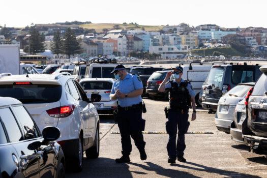Police conduct public health order compliance checks as people arrive at Bondi Beach in Sydney, Australia, on Aug. 15, 2021. (Brook Mitchell/Getty Images)