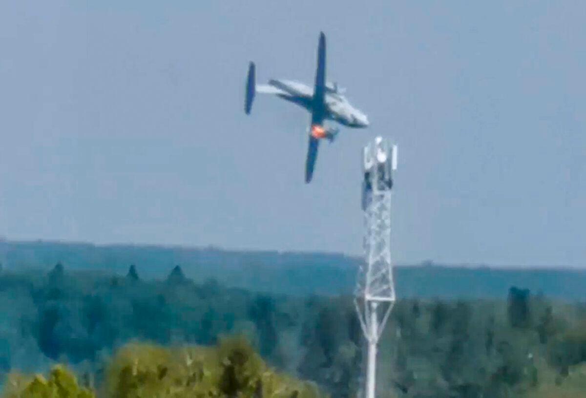 In this handout photo taken from video, the new light military transport burning plane Il-112V flies down near Kubinka airfield about 45 kilometers (28 miles) west of Moscow, Russia, on Aug. 17, 2021. (Dmitry Ovchinnikov via AP)