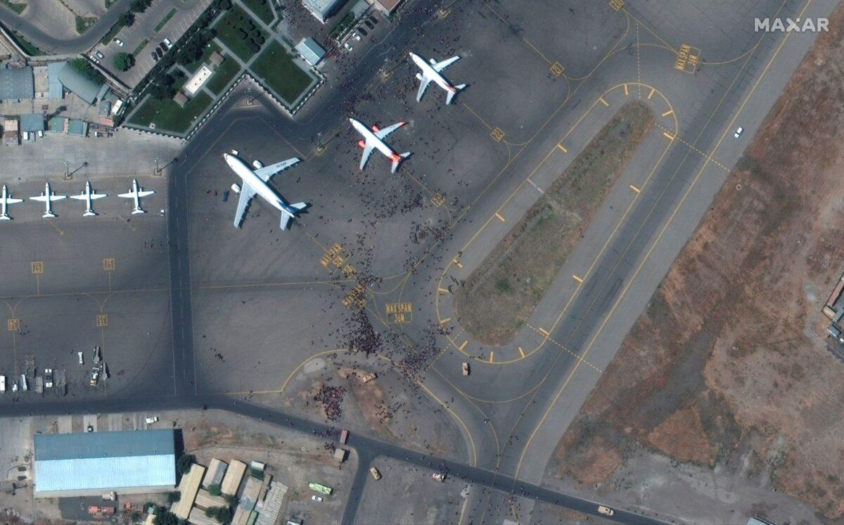 This satellite photo from Maxar Technologies shows swarms of people on the tarmac at Kabul International Airport, also known as Hamid Karzai International Airport, on Aug. 16, 2021. (Satellite image ©2021 Maxar Technologies via AP)
